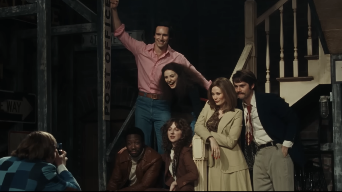 cast standing on stairs