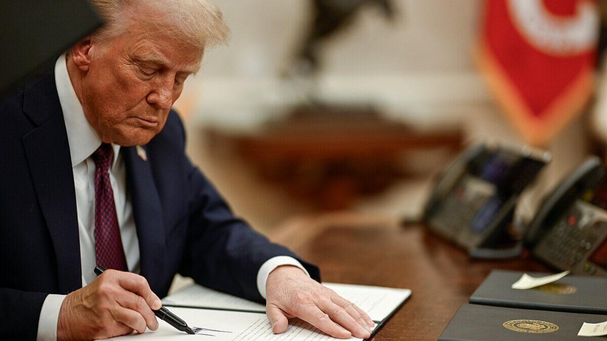 Donald Trump signing executive orders.