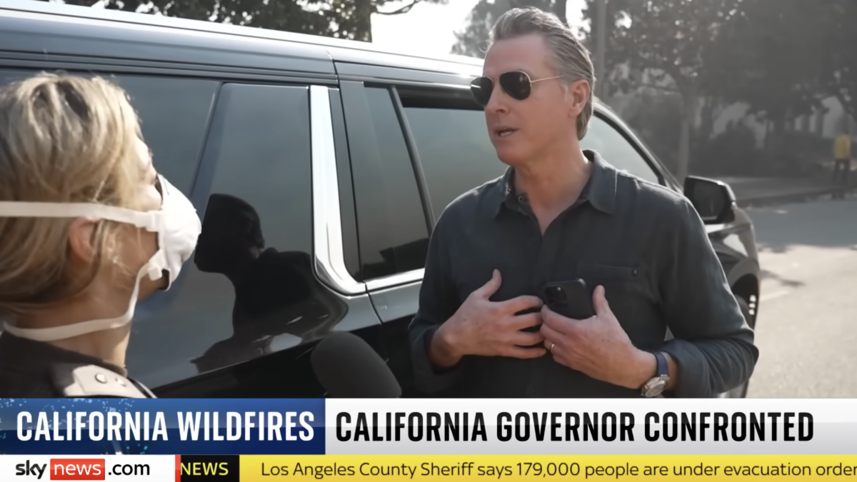 Gavin Newsom in front of car during interview