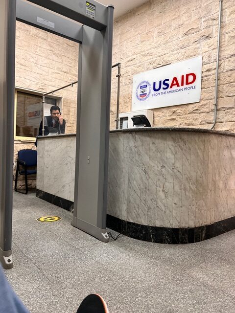 security guard talks on the phone at USAID