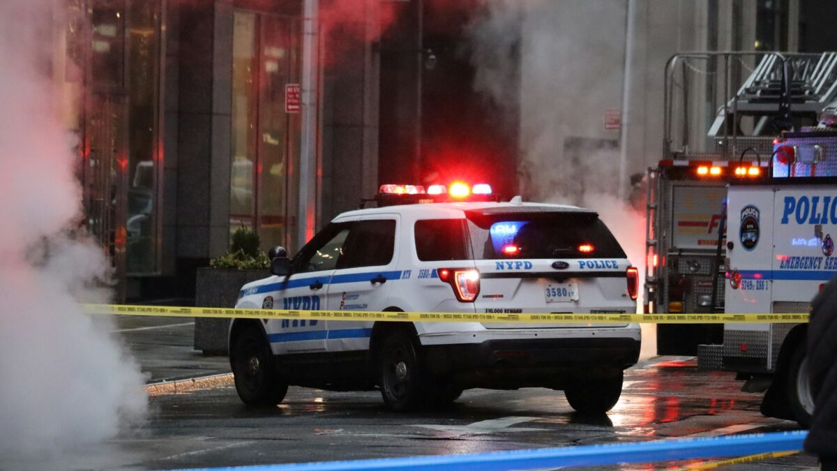 NYPD Car behind crime scene tape