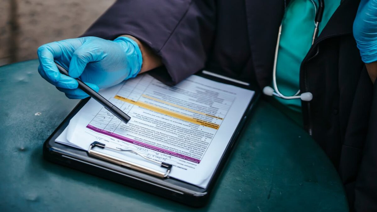 doctor fills out paperwork on clip board closeup