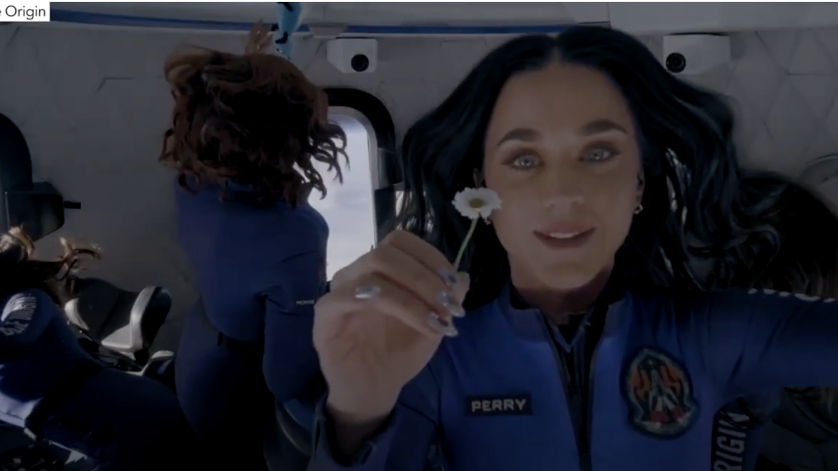 Pop singer Katy Perry holds up a flower during the Blue Origin flight.