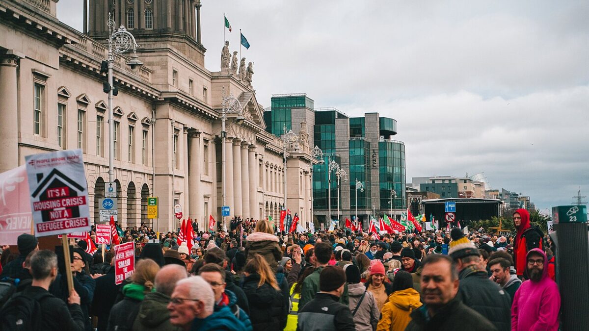 rally outside of building in Ireland with flags