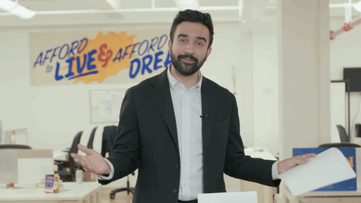 Mamdani standing in his office looking dumb