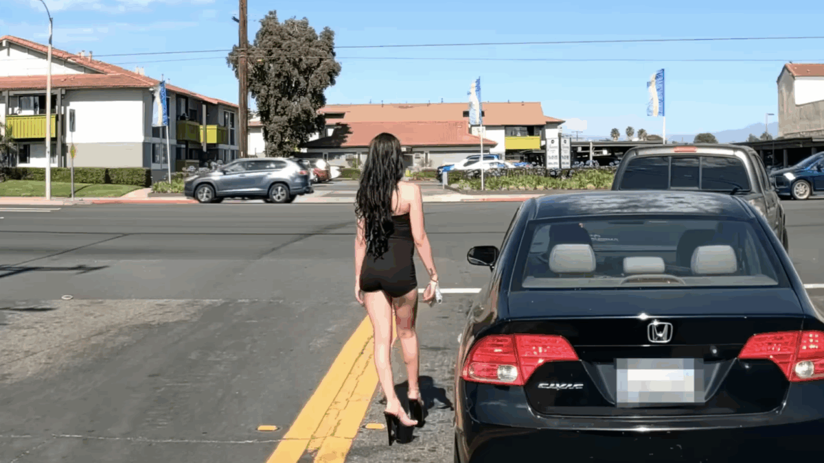woman walking in middle of street in heels