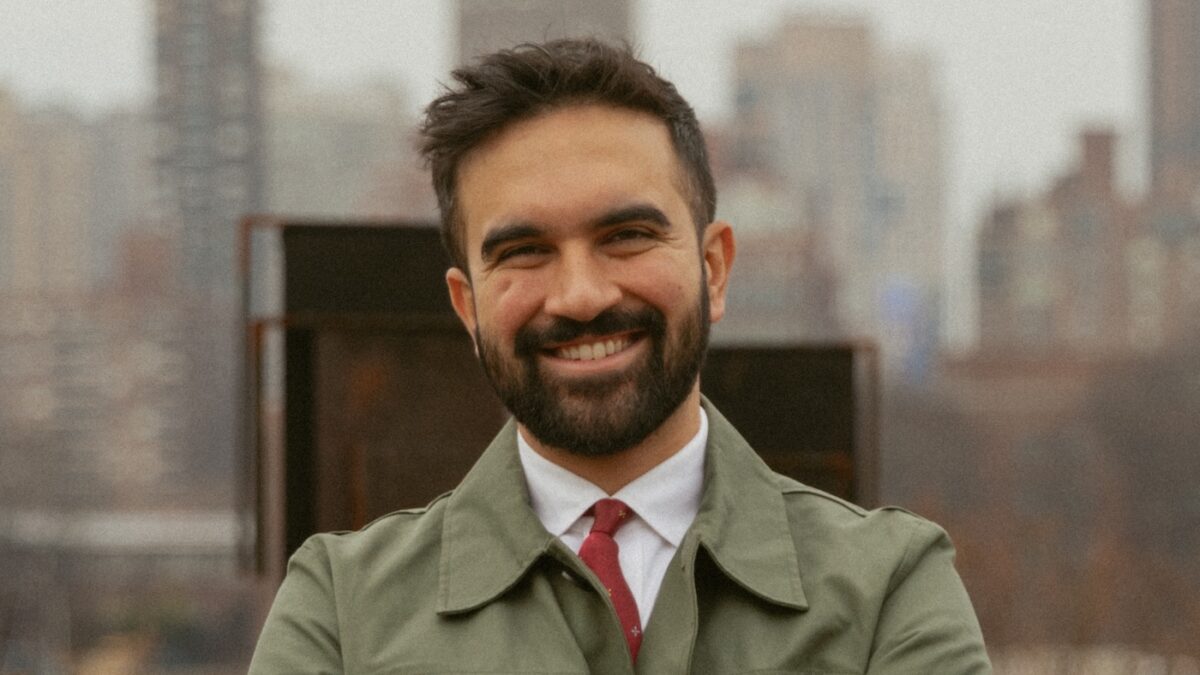 Zohran Mamdani with NYC skyline in background