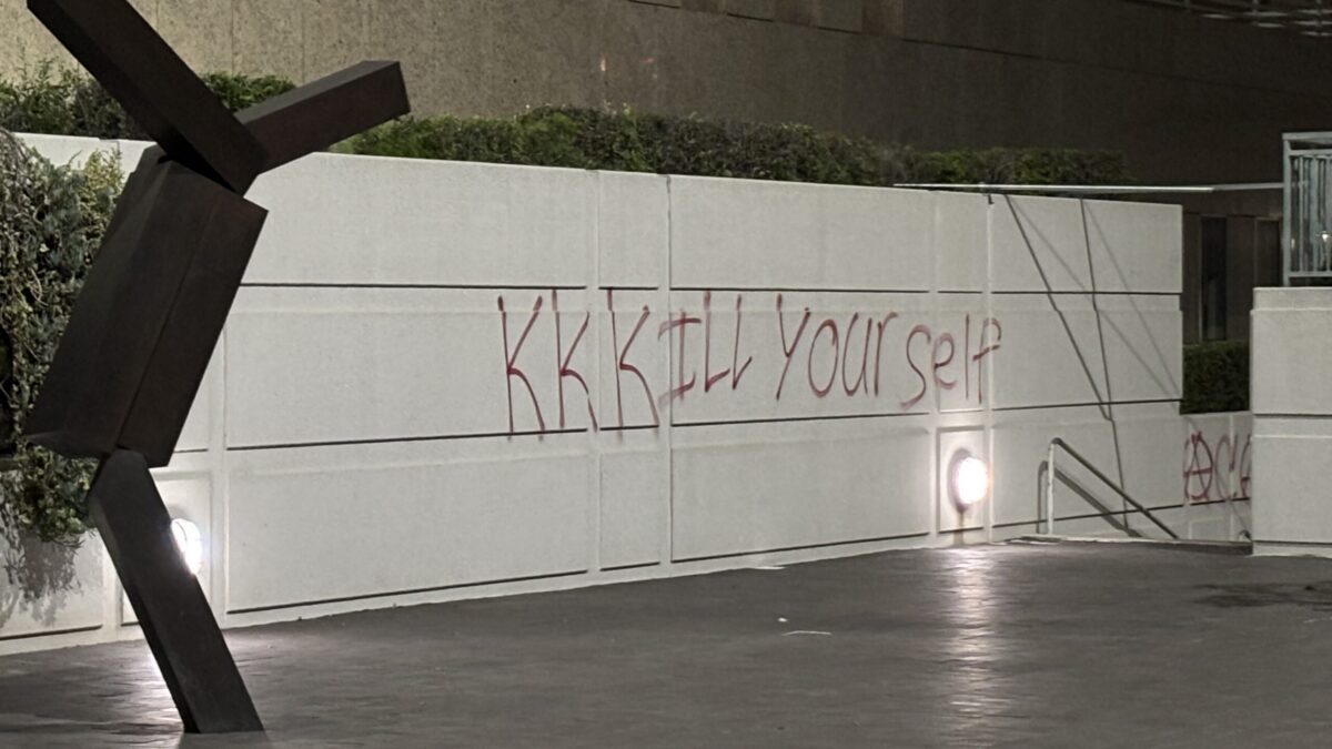 Graffiti at the federal buildings in Downtown Los Angeles compares immigration officials to the KKK.