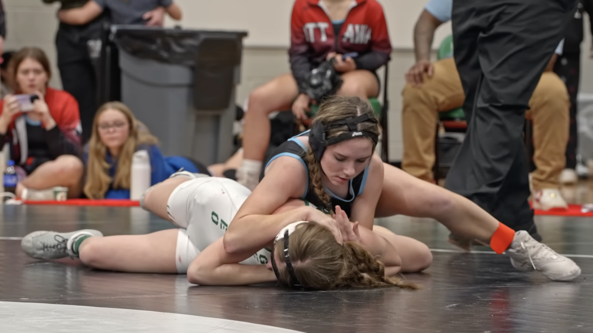 girls wrestlng in gym on mat