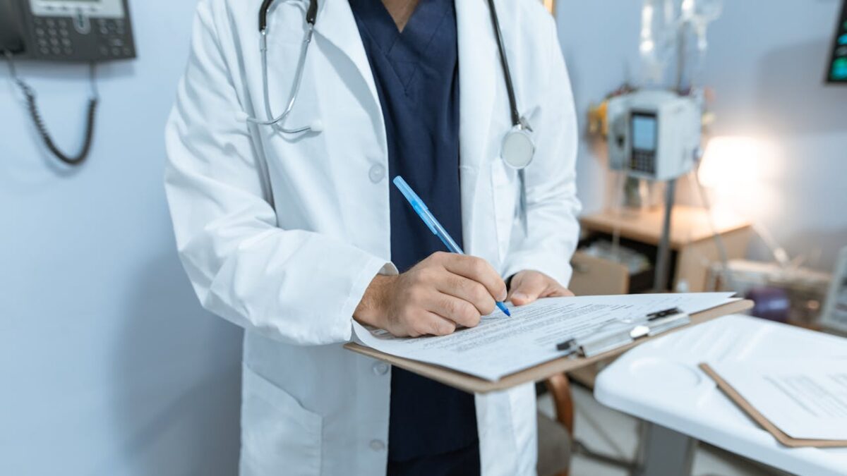 doctor writing on a clipboard