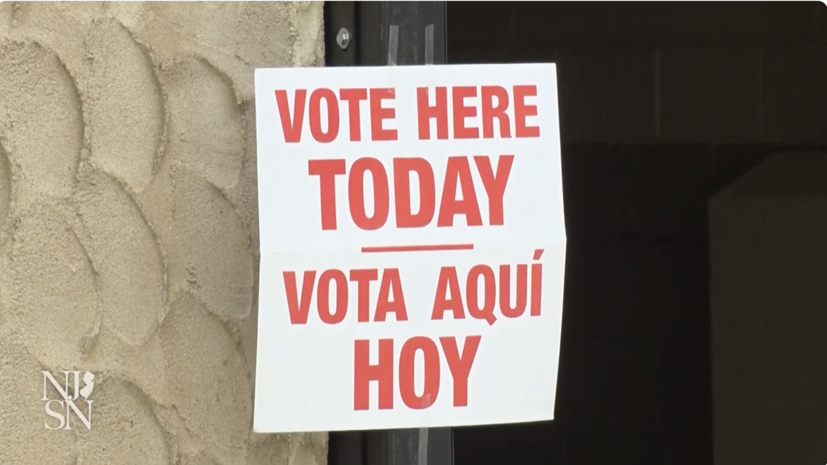 A sign - in English and Spanish - reminding New Jersey voters to vote.