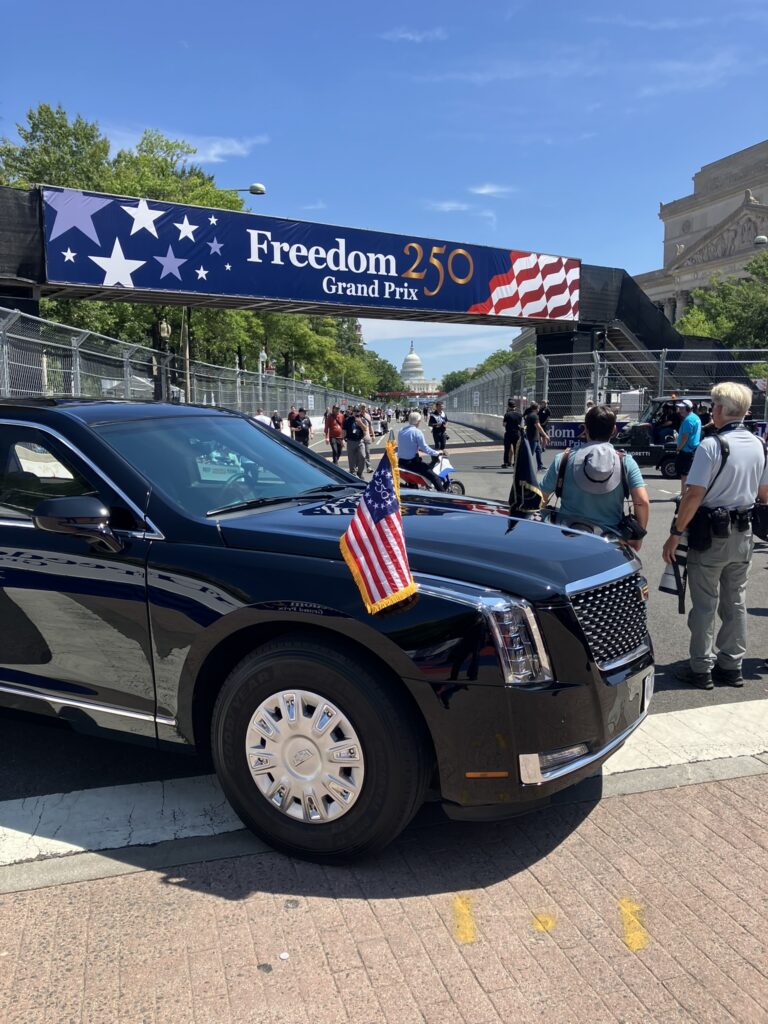 Black car under freedom 250 grand prix sign