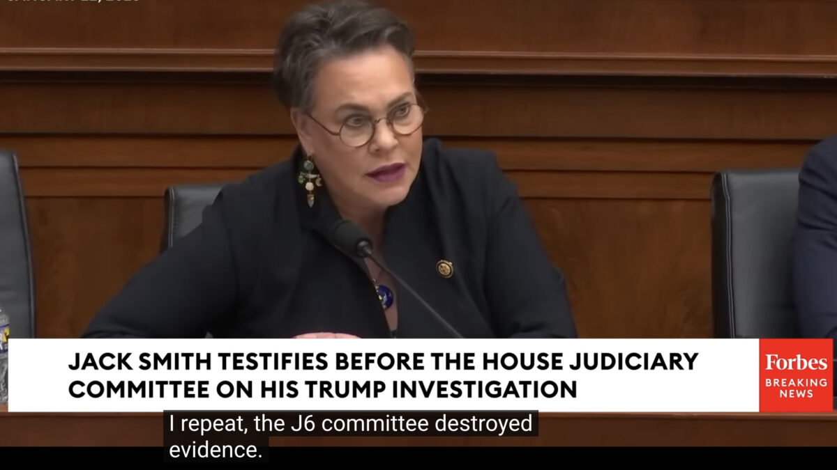 Congresswoman Harriet Hageman leans forward and speaks emphatically during a congressional hearing.