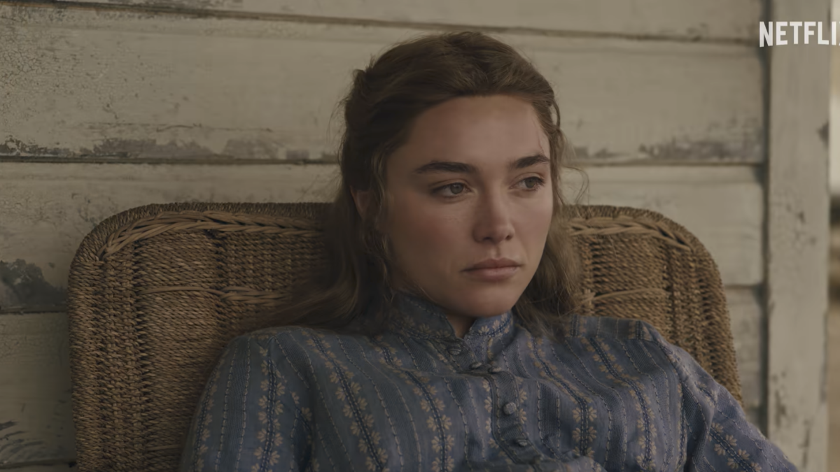 woman staring off sitting in chair on front porch