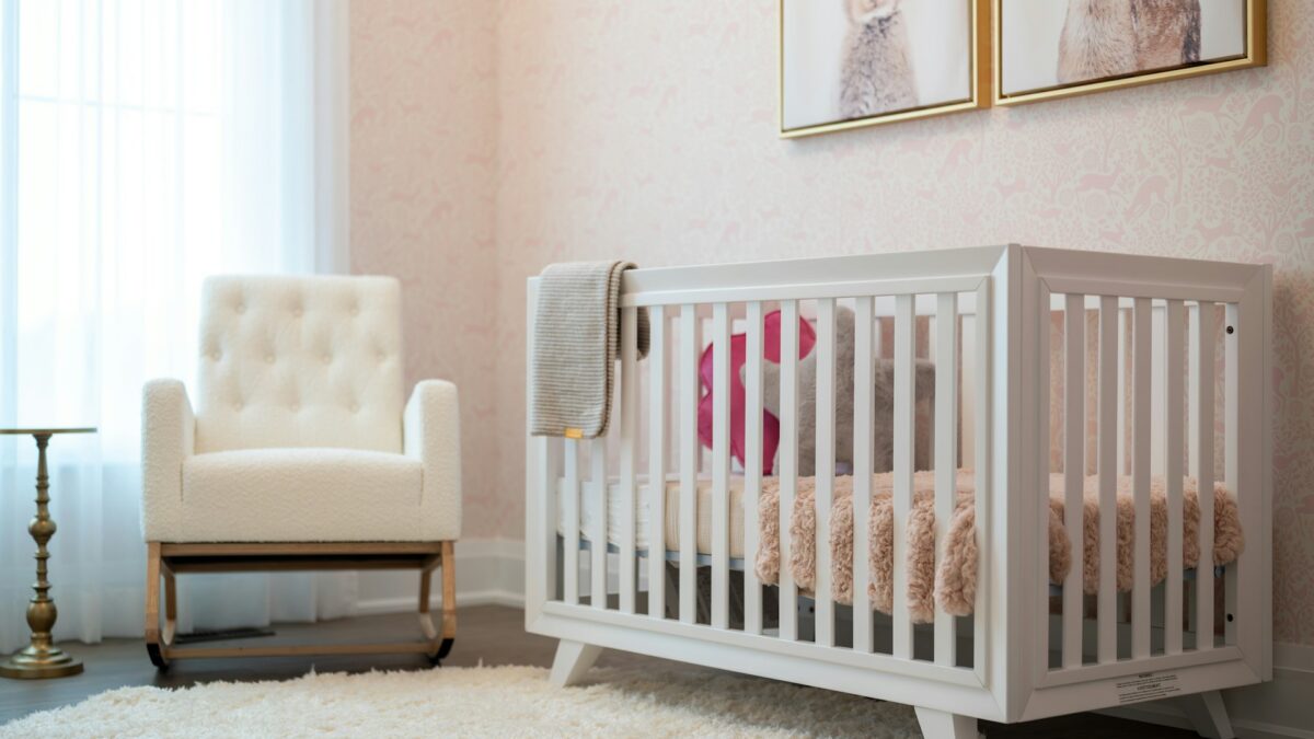 empty baby nursery with crib and chair
