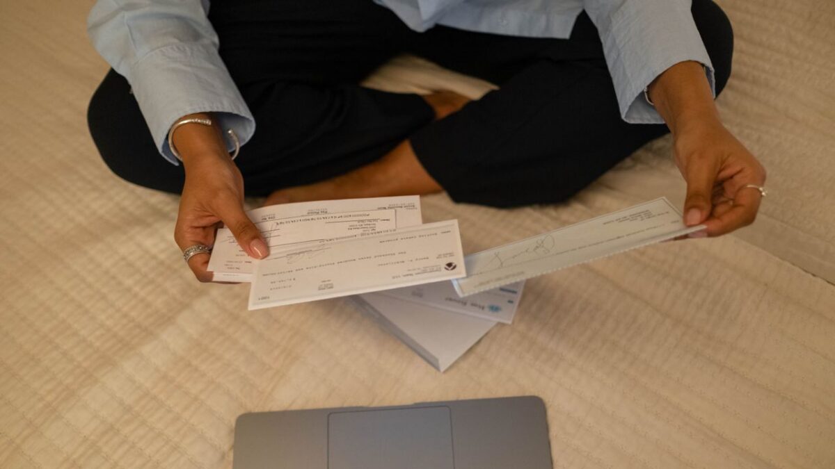 woman holding a paycheck