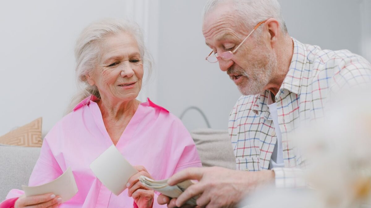 two old people opening mail and reading documents